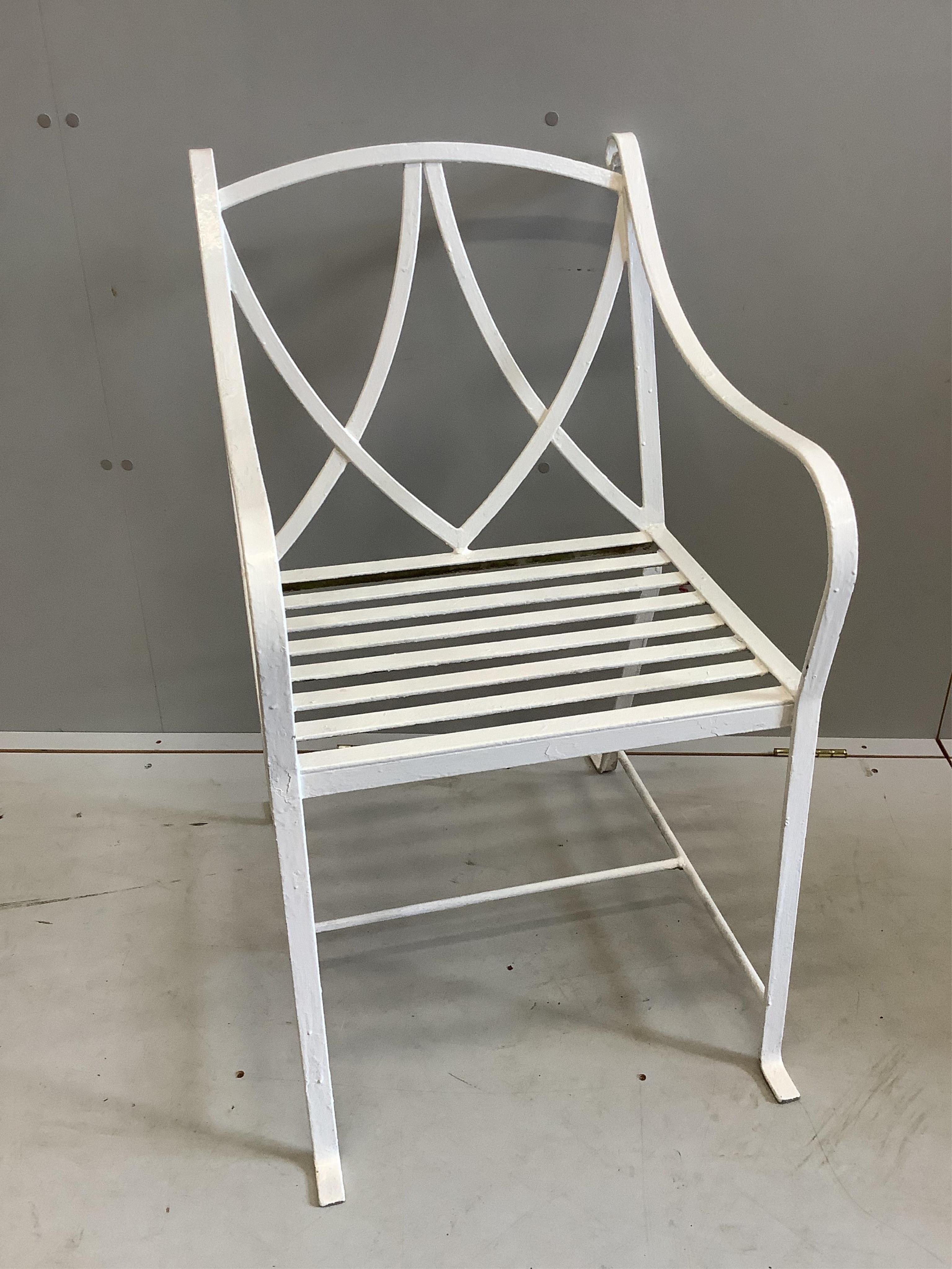 A set of four painted wrought iron strapwork garden chairs, width 51cm, depth 64cm, height 90cm. Condition - good